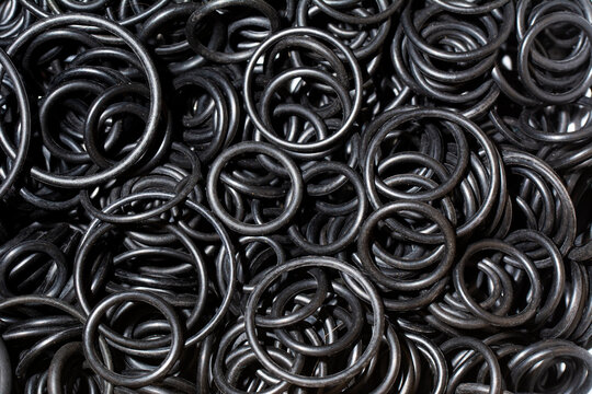 Seal O-ring black rubber. Sealing NBR gaskets for hydraulic system. Chemical resistant Spare part. Industrial background.
