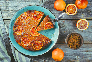 Modern style traditional Italian blood orange ricotta pie with fruits and almonds served as top...