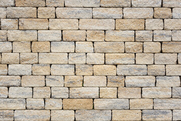 Texture of a wall made of rectangular bricks that form a gray brick wall