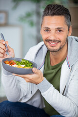 young man eating a healthy salad