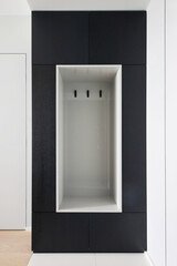 minimalistic entrance hall with a hanger mirror shelf and pouf