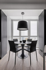 dining area with leather chairs in the studio in monochrome colors