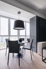 dining area with leather chairs in the studio in monochrome colors