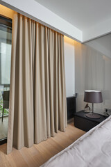 a bed with a soft headboard and lamps on the bedside tables in the hotel room 