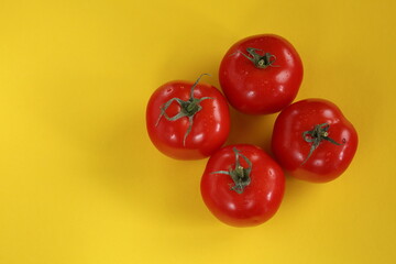 tomatoes on yellow background top view