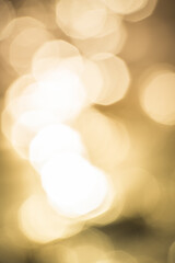 Bokeh shapes and shadows on water surface on the coast creating texture and patterned backgrounds and backdrops.