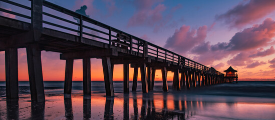 Panoramic old Naples Pier Florida USA. Boardwalk at sunset.