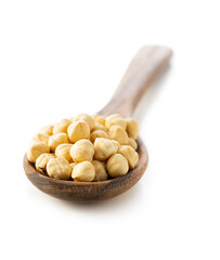 Peeled roasted hazelnuts in wooden spoon.