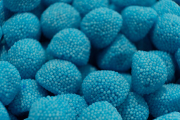 Sweet jelly look like blue raspberry and candies with sugar. Macro.