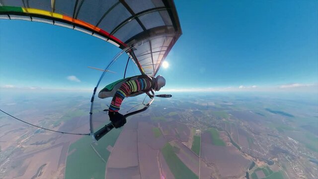 Bright rainbow colored hang glider on high altitude