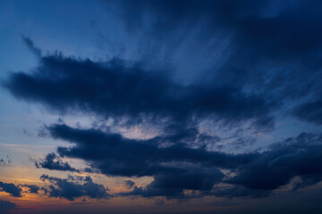 beautiful sunset sky, dark silhouette of clouds as a background