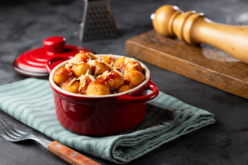 Gnocchi with tomato sauce and grated Parmesan cheese.