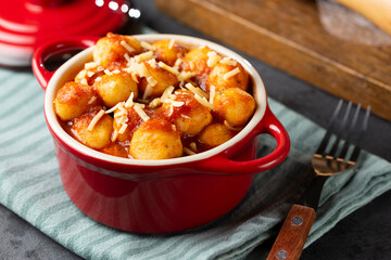 Gnocchi with tomato sauce and grated Parmesan cheese.