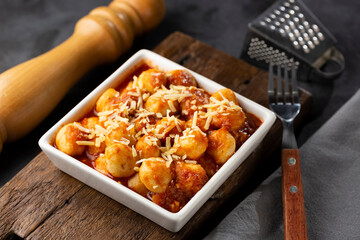 Gnocchi with tomato sauce and grated Parmesan cheese.