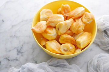 top view of slice of jackfruits in a bowl on table.
