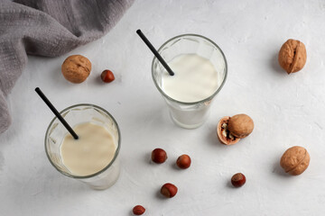 Healthy food concept. Natural breakfast. In glass glasses, nut milk on a light background. Organic vegetarian drinks.