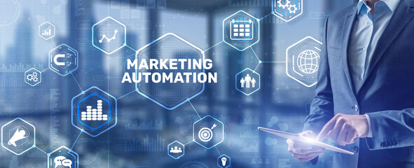 Marketing automation on the virtual screen. Man clicks on the inscription Marketing