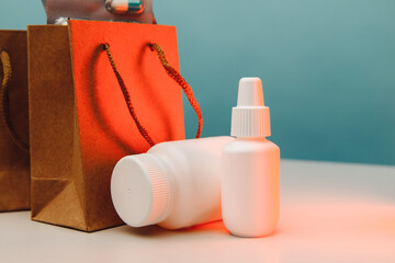 Online shopping theme. Paper bags with medical white containers and pills close-up