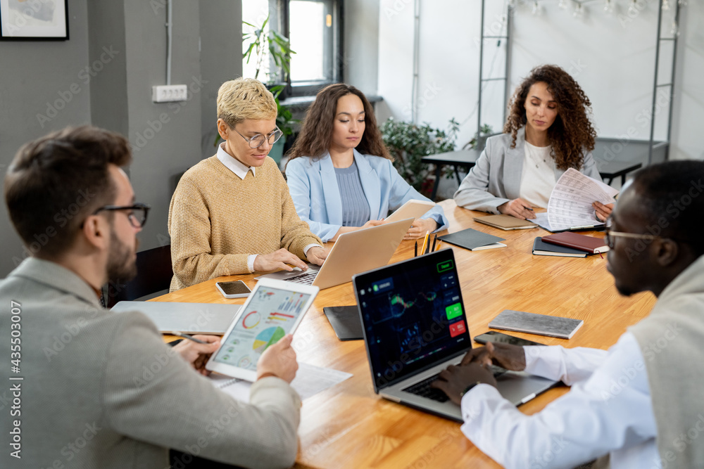 Sticker large group of financier working individually by table in office