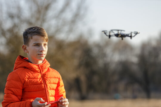 Teenage Boy Flying Small Drone In The Park