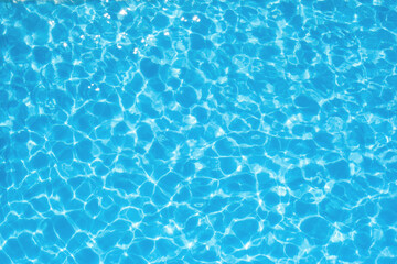 The water ripples in a blue transparent pool. Waves and ripples in the pool.