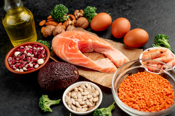 Different foods sources of omega-3 acids on a stone background