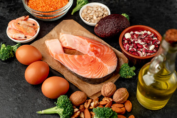 Different foods sources of omega-3 acids on a stone background