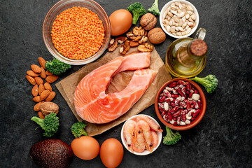 Different foods sources of omega-3 acids on a stone background