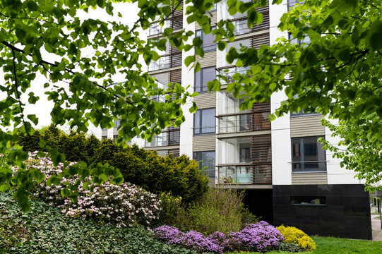 Cityscape of a residential area with modern apartment buildings, new green urban landscape in the city, green trees and flowers in garden