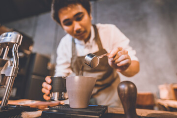 Fototapeta na wymiar professional barista making hot drink of a fresh coffee in vintage cafe, cup of brown aroma hot espresso with milk, beverage caffeine for morning, coffee bean and breakfast background