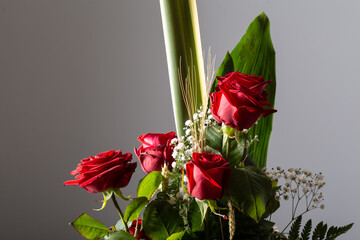 Red roses bouquet isolated on a grey background