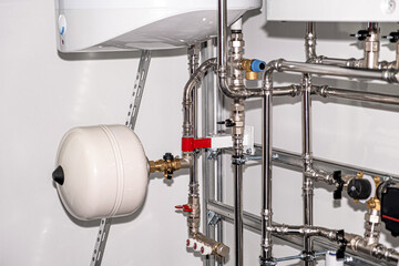 Plumbing services. Stainless steel piping of the heating system in the boiler room. Heating thermoregulation system. Pump and sensors.