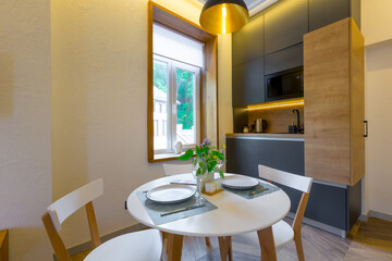 Interior photography, loft style, small apartment with warm light and dark kitchen
