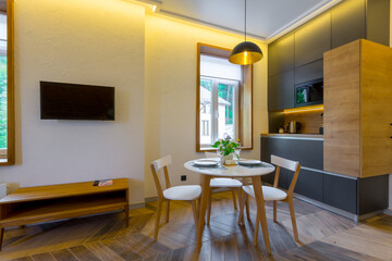 Interior photography, loft style, small apartment with warm light and dark kitchen