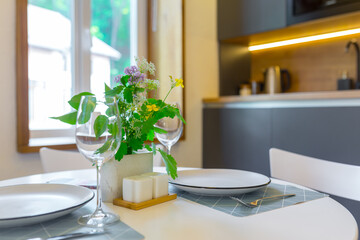 Interior photography, loft style, small apartment with warm light and dark kitchen