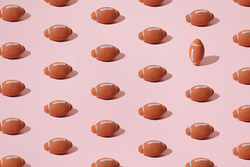 Sorted balls for American football on a pink background. Rugby pattern.