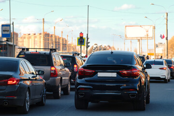 Background, blur, out of focus, bokeh. Traffic jams during rush hours after work. Red brake lights of stopped cars on the background of the city neighborhood.