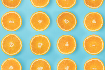 Arranged sliced ​​orange. Slices lined up on a blue background.