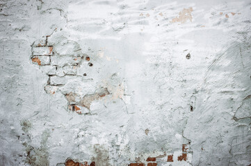 Old plastered brick wall. Urban architecture. Repairs. Collapsed brickwork. White brick background.