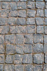 An old stone pavement. The old road. Stone masonry. Gray granite. Square cut stone masonry. Roads of the old city.