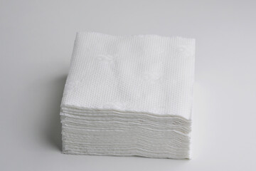 White square bar napkins isolated. Stack of clean paper tissues on white background. Stack of new white folded towels.