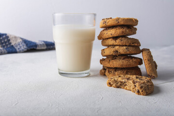 tasty cookies with chocolate chips and a glass of milk