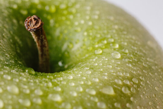 Closeup of green apple with water drops