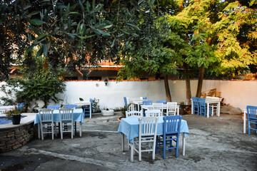 Aegean Mediterranean restaurant in a lovely garden, white and blue chiars and tables