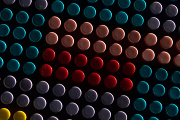 childish game background: darkened plane of plastic multi-colored bricks, blur, selective focus