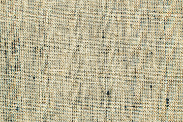 dark creative background: reverse side of black-primed linen canvas, uneven lighting, color toning