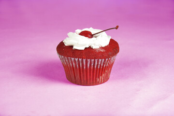 delicious cherry cupcake on a pink background