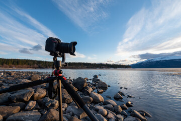 DSLR camera sitting on a rock lake shore in northern Canada taking photos for photography, hobby or...
