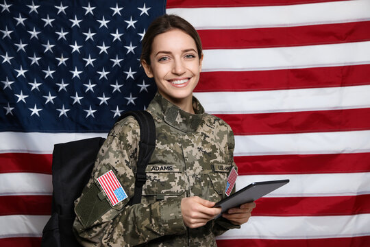 Female cadet with backpack and tablet against American flag. Military education