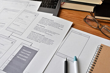 On the desk where I am doing web design. There is a wireframe printable and a pen.